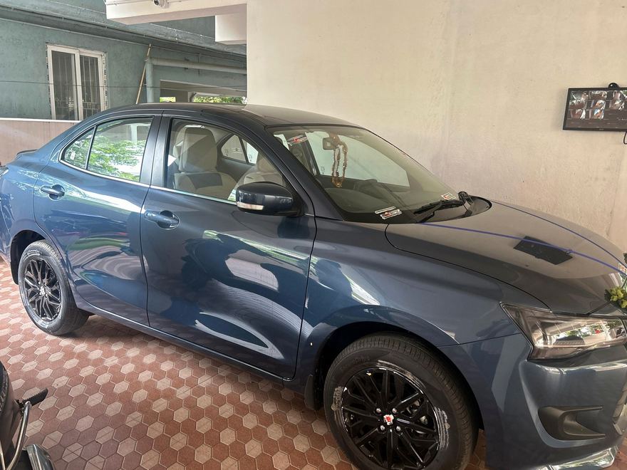 Blue 2026 Maruti Swift Dzire ZXi, front three-quarter view